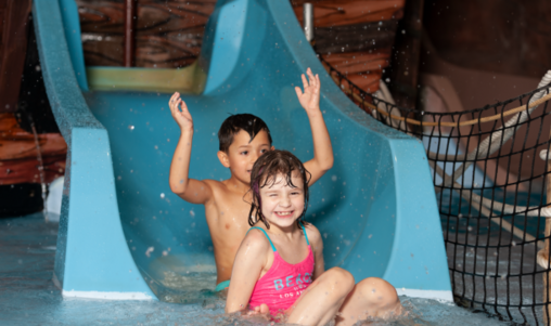 Deux enfants s'amusent dans un toboggan du Bateau Pirate d'Aquaparc